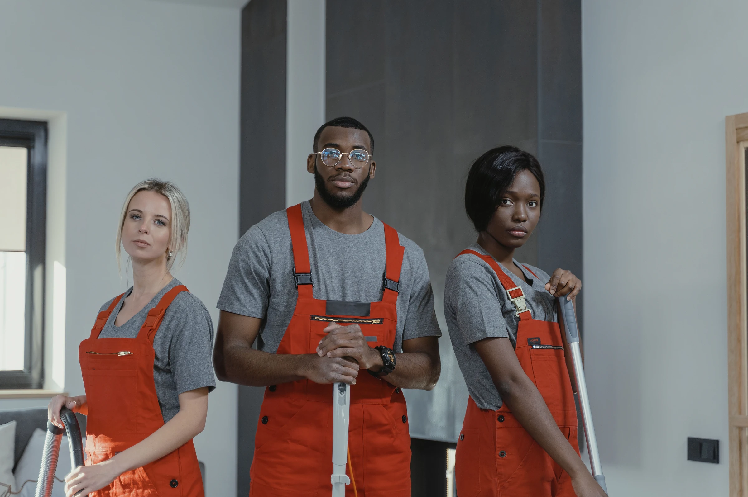 Three cleaners in overalls ready to start