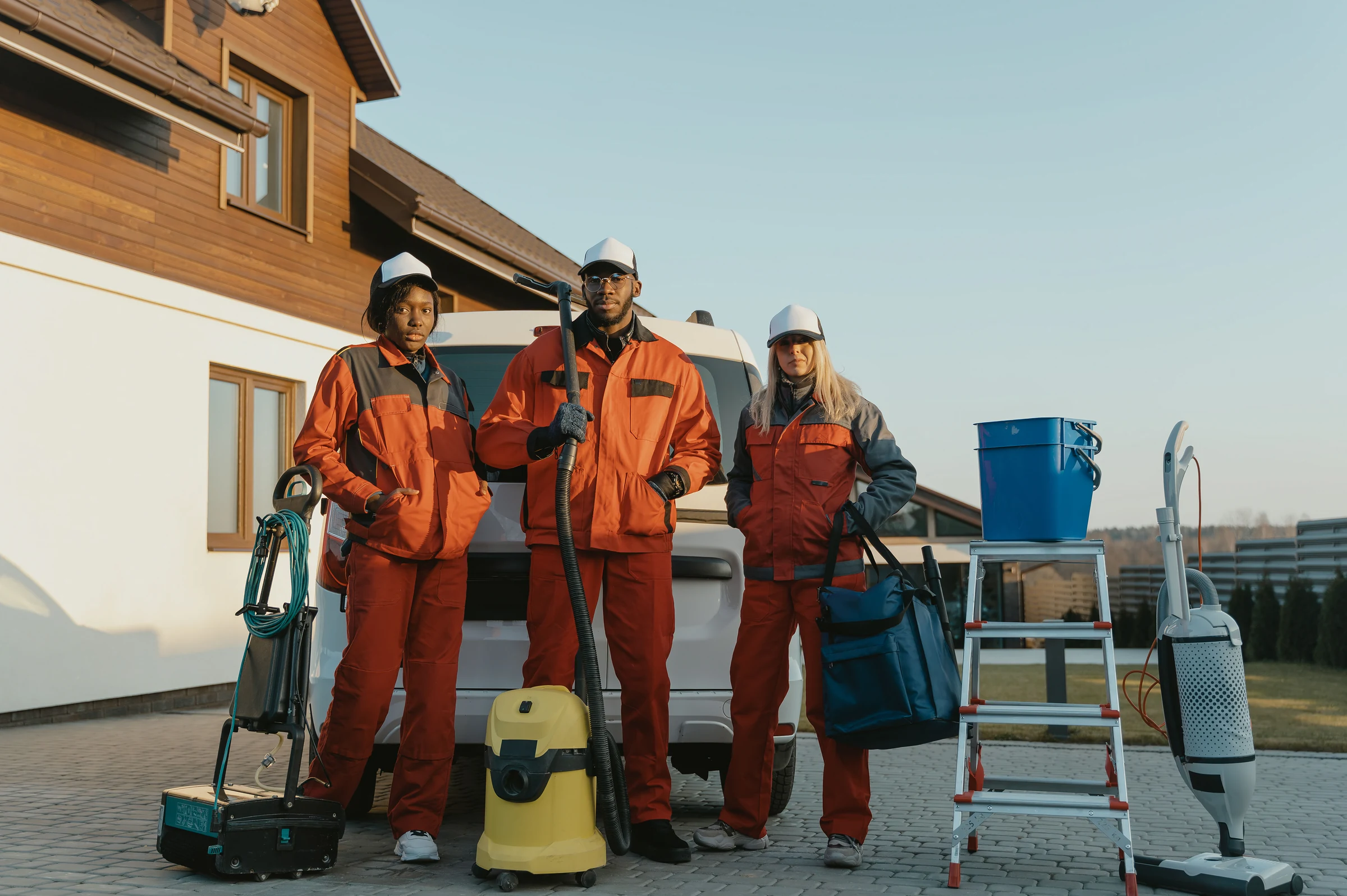 The cleaning crew with their kit beside the van